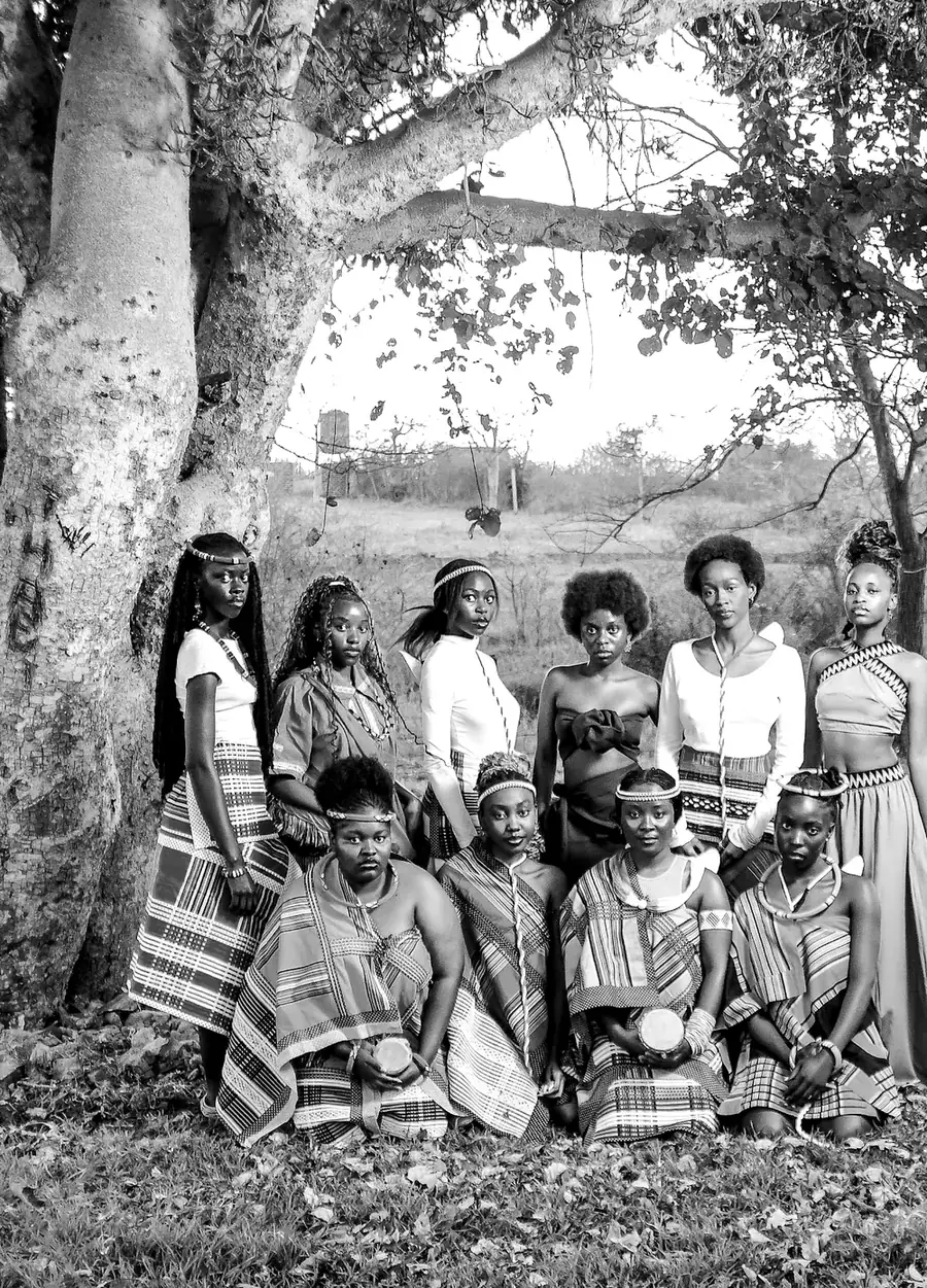 A group of women in Venda minwenda gathered in the shade of a great tree.